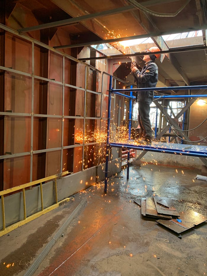 pexels-photo-4025501 Welder working inside industrial building
